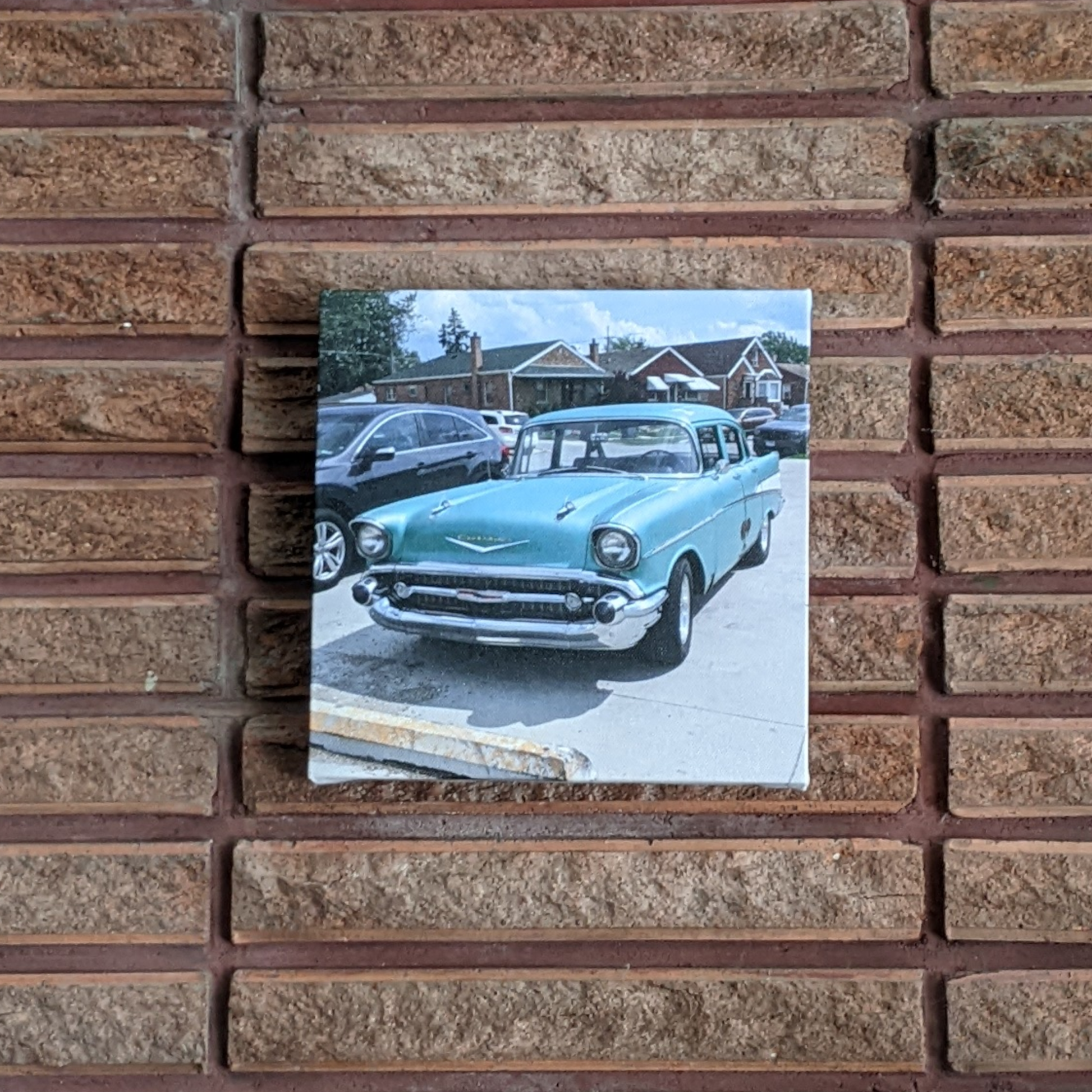 Square canvas print of a 1957 Chevrolet Bel Air, great for home or office décor in a Classic car themed room. Displayed on a red-brick wall.